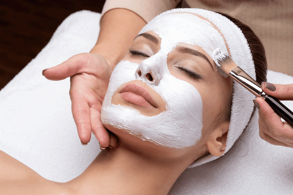 Woman with a smooth, evenly applied beauty mask on her face, promoting skincare and self-care.